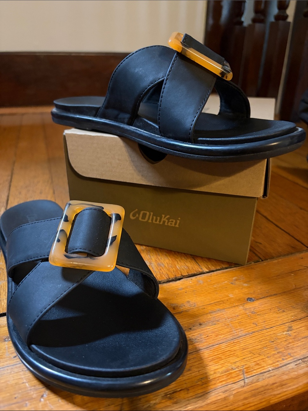 OluKai Black Slide Sandals with Amber Accent Buckle